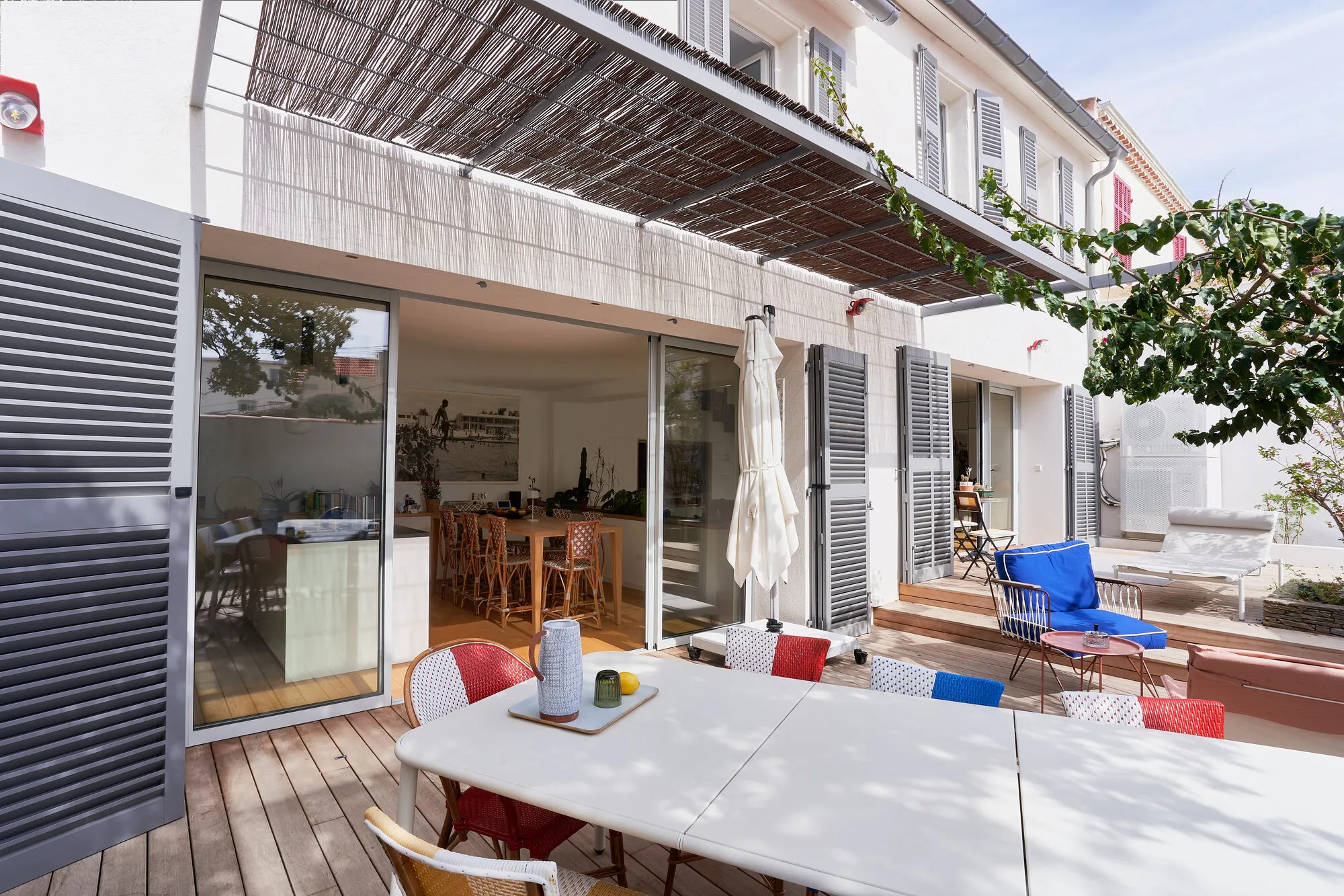 Terrasse bois et façade aux grandes baies vitrées