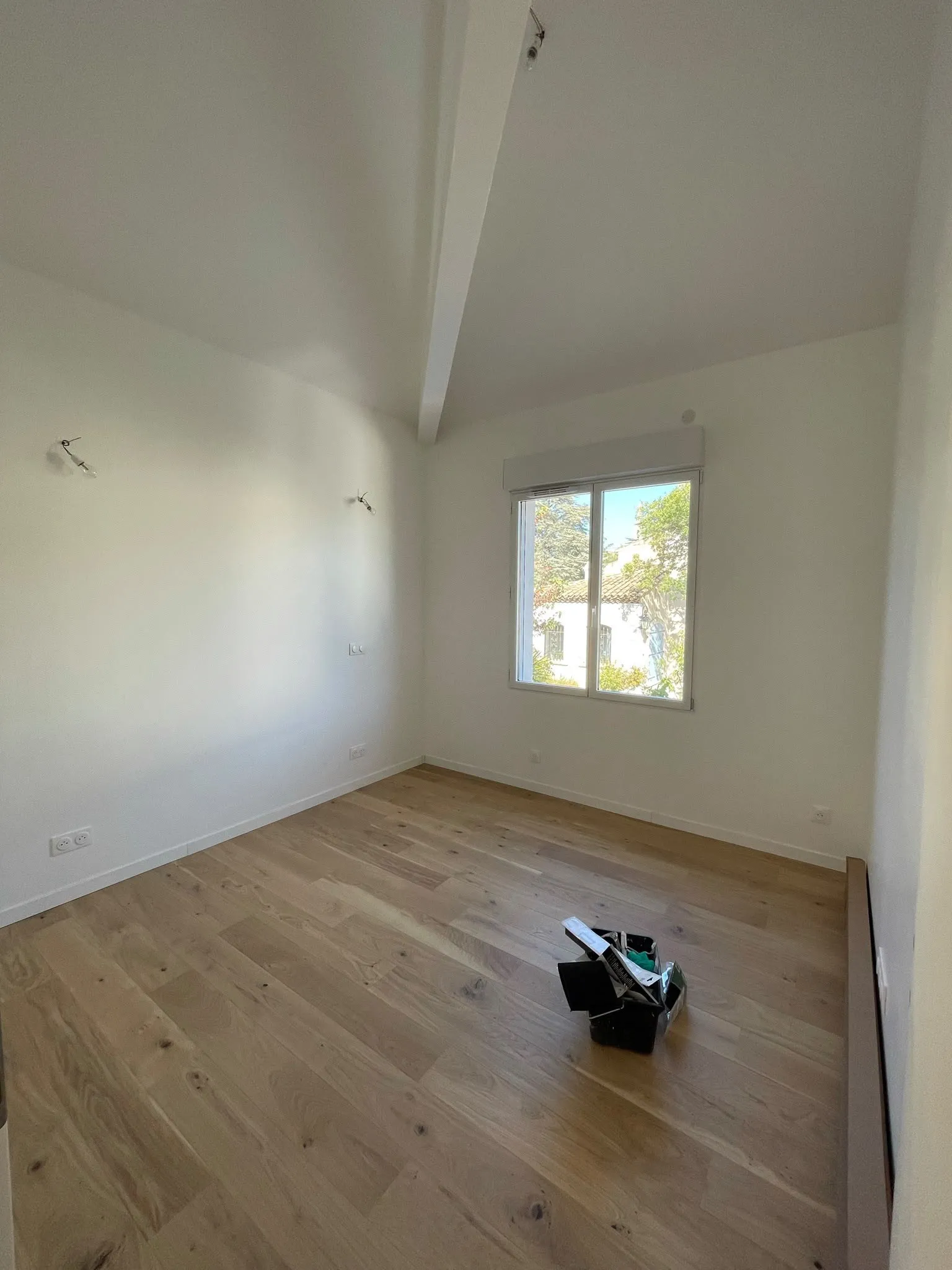 Chambre repeinte en blanc avec parquet chêne